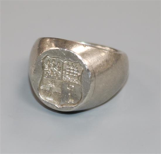 A white metal heavy signet ring, with intaglio crest, size H.